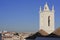 A church tower and the rooftops of the skyline of Tavira, Portugal