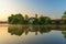 Church and tree on pond bank in sunrise, Blato.