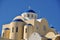 A church with the typical blue roof in Fira or Thira on the island of Santorini. Greece