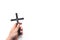 Church utensils. Man holding a crucifix. Closeup of wooden christian cross in the hand on the white isolated background.