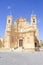 Church view with red phone booth, Gharb, Malta