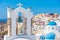 Churches and blue cupolas of Oia town at Santorini, Greece