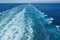 The churning blue water of a cruise ship wake on the Atlantic Ocean