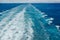 The churning blue water of a cruise ship wake on the Atlantic Ocean