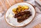 Churrasco grilled veal ribs with baked potatoes and garlic aioli