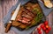 Churrasco of meat cut into pieces on a wooden board in a rustic setting. Aereal View - Landscape