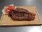 CHURRASCO FROM SOLOMO TO THE BRAZIL ON WOODEN TABLE WELL COOKED GOLDEN AND APPETIZING