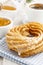 Churro donuts and bowl of honey