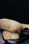 Ciabatta bread on a wooden board. Freshly baked traditional italian bread on the black table.