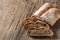 Ciabatta. Dark fresh healthy flattish open-textured Italian bread with a floury crust on wooden background. Close-up