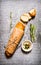 Ciabatta wrapped in paper with rosemary and oil.