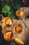 Cider glasses: apple, pear and orange drinks. Fermented low alcohol fruit coctail on old wooden table background with leaves