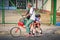 Cienfuegos, Cuba - 01/04/2017: Grandpa taking his granddaughter from school on a bike