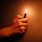 Cigarette lighter igniting by a hand