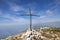 Cima delle Pozzette, wooden cross on the top of a mountain, turistic train Alta Via del Monte Baldo