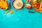 Cinco de Mayo holiday celebration with nacho chips, peppers, maracas and mexican party decorations on blue wooden background. Top