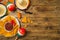 Cinco de Mayo Mexican holiday party concept with Nacho chips and sombrero hat on wooden background. Top view from above