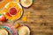 Cinco de Mayo Mexican holiday table arrangement for party. Nacho chips and sombrero hat on wooden background. Top view, flat lay