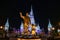 Cinderella Castle, with Christmas icicles behind the statue of Walt Disnsy and Mickey Mouse