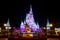 Cinderella Castle, with Christmas icicles behind the statue of Walt Disnsy and Mickey Mouse