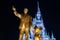 Cinderella Castle, with Christmas icicles behind the statue of Walt Disnsy and Mickey Mouse