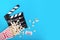 Cinema background. Popcorn and clapperboard on blue background