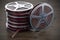 Cinema concept. Film reels on the wooden table, 3D rendering