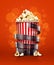 Cinema concept with paper bucket with popcorn and film tape