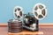 Cinema projector with movie reels on the wooden floor. 3D render