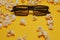 Cinema session, film, popcorn, 3D glasses. View movie concept, cinema, discounts. Yellow cinema background. Glasses for 3D movie