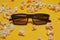 Cinema session, film, popcorn, 3D glasses. View movie concept, cinema, discounts. Yellow cinema background. Glasses for 3D movie