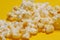 Cinema session, film, popcorn, 3D glasses. View movie concept, discounts. Background of yellow popcorn. Close-up popcorn on a