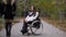 Cinemagraph. Attractive girl on a wheelchair walking in the autumn park. Disabled leisure