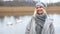 Cinemagraph of blond woman standing in front of lake with swans