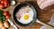 Cinemagraph - Cooking egg with bacon in a frying pan.