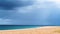 Cinemagraph Of A Couple Walking Along A Sandy Beach With Clouds Moving Overhead, looping footage