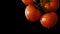 Cinemagraph - Drops of water dripping from above ripe tomatoes.