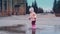 Cinemagraph: little child is jumping in a puddle, leaving a lot of spray
