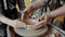 Cinemagraph loop of man and boy`s hands holding ceramic bowl rotating on throwing wheel