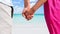 CINEMAGRAPH - seamless loop: Holding hands romantic newlyweds couple on beach