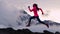 CINEMAGRAPH - seamless loop. Running woman runner athlete silhouette trail running with mountain summit background with