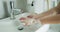 Cinemagraph - seamless loop. Washing hands woman rinsing soap with running water at sink, Coronavirus prevention hand