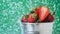 cinemagraph of strawberries in a metal bucket closeup under the water drops in green background. Healthy lifestyle.