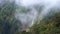 Cinemagraph of Thick Forest Fog and Smoke Moving in Mountain with Waterfall