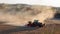 Cinemagraph of a tractor driving on a dusty dry field