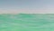 Cinemagraph of underwater split shot view showing above and below the water level of the Dead Sea in Israel