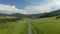 Cinematic aerial drone footage driving through beautiful landscapes with mountains. Road. Aerial view.