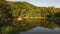 Cinematic aerial move above mountain lake betwin trees