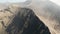 Cinematic aerial view of Mount Bromo crater edge with active volcano smoke in East Java