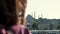 Cinematic close-up, happy young tourist woman watching beautiful view of Hagia Sophia, Turkey on summer sunset vacation.